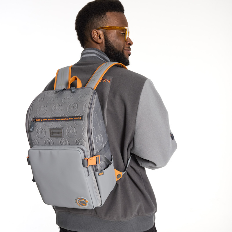 Man with dark beard and glasses facing away from camera and wearing the Loungefly COLLECTIV Star Wars Rebel Alliance The MULTI-TASKR Full-Size Backpack 